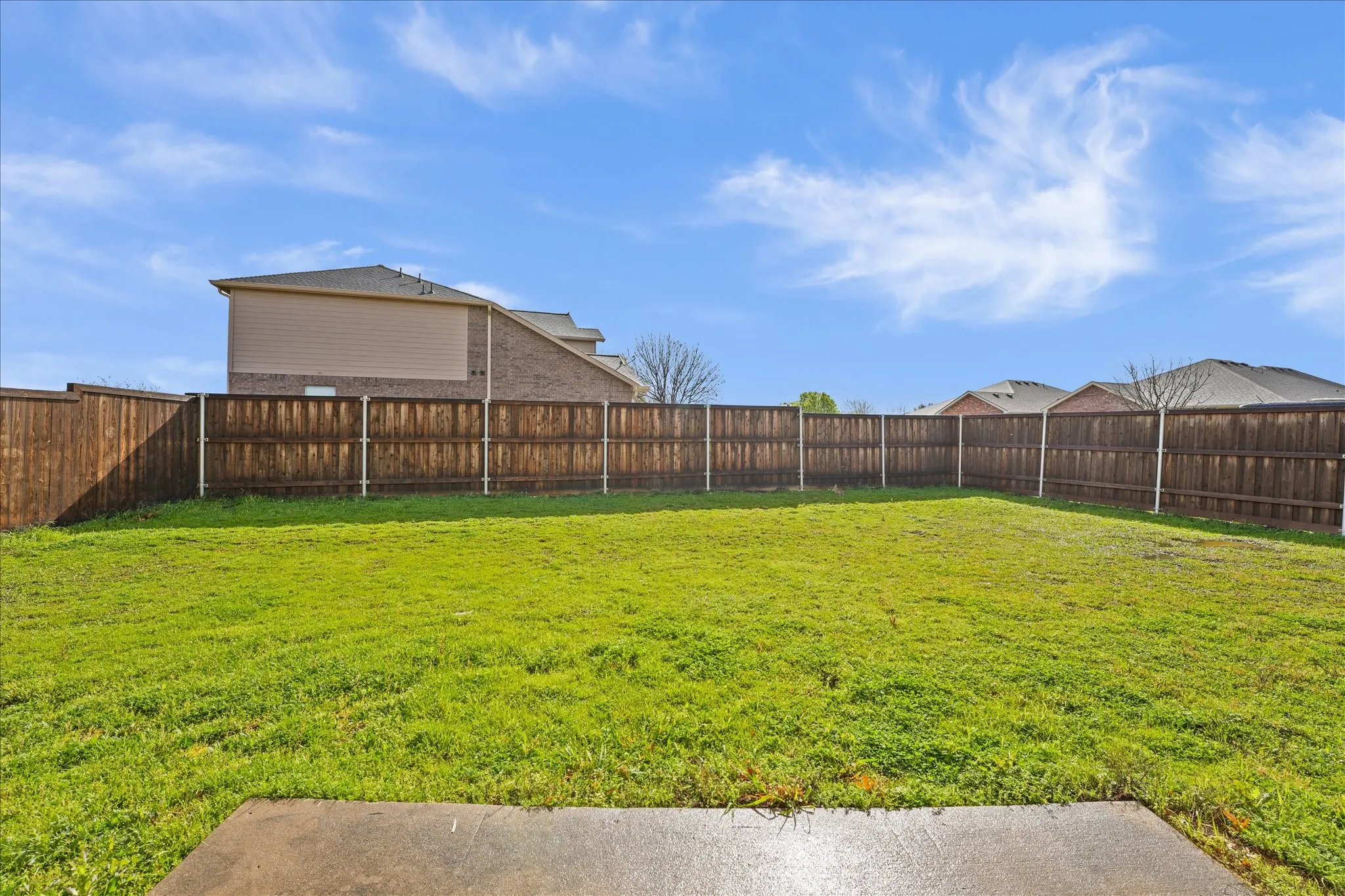 View of fenced backyard