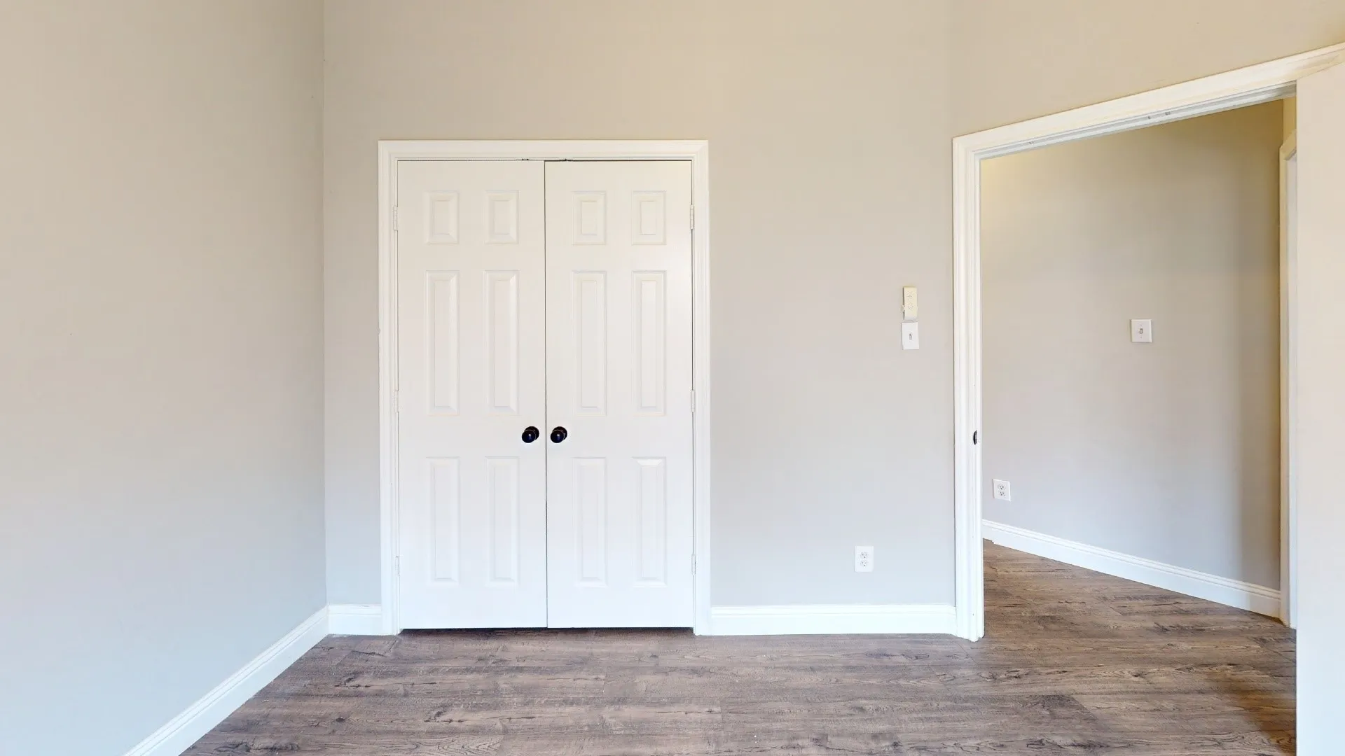 Interior room featuring wood-finish flooring and light-toned walls