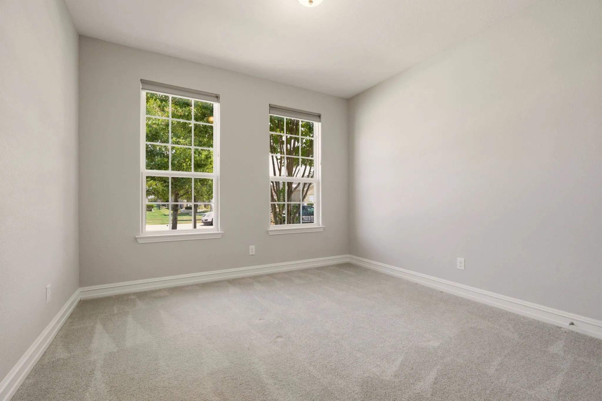 Secondary bedroom at front of home, adjacent to full bath.
