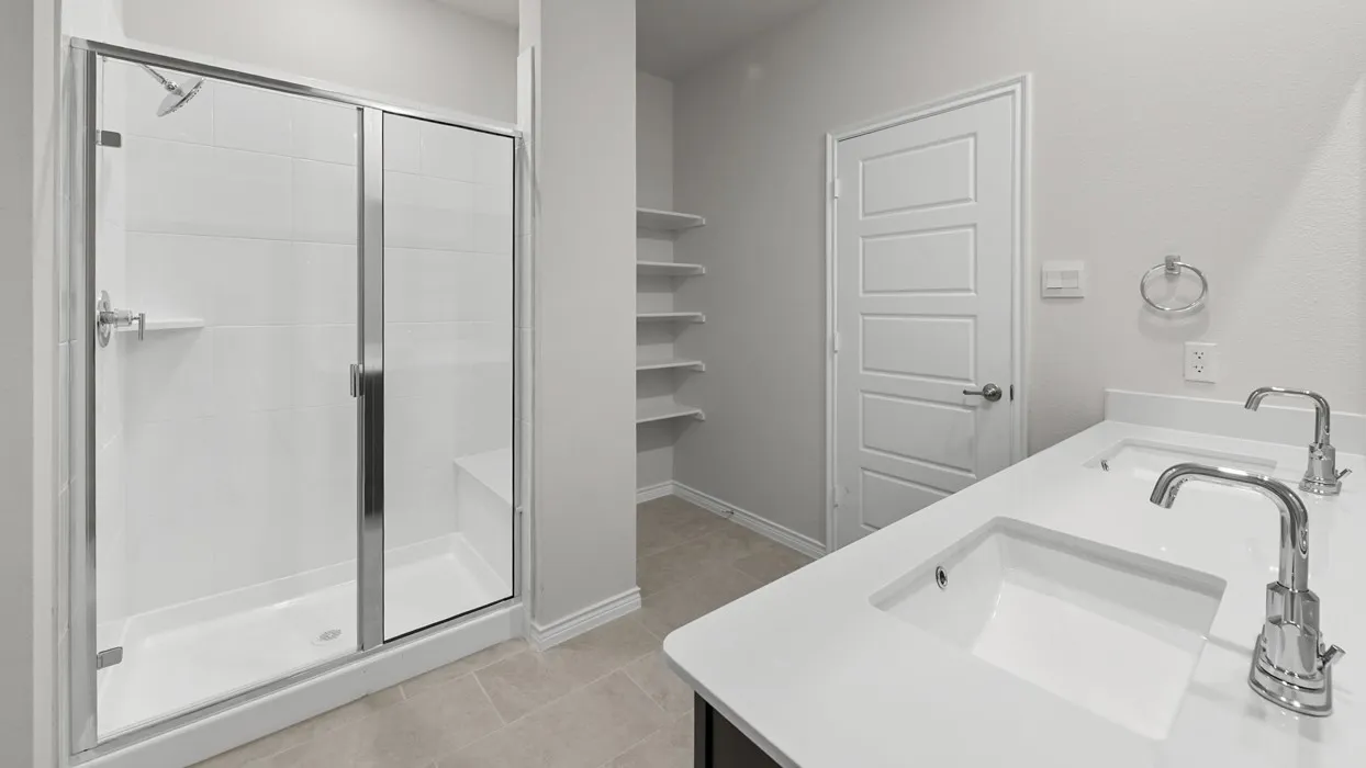 Dual vanity with integrated sinks and chrome fixtures, featuring a white countertop