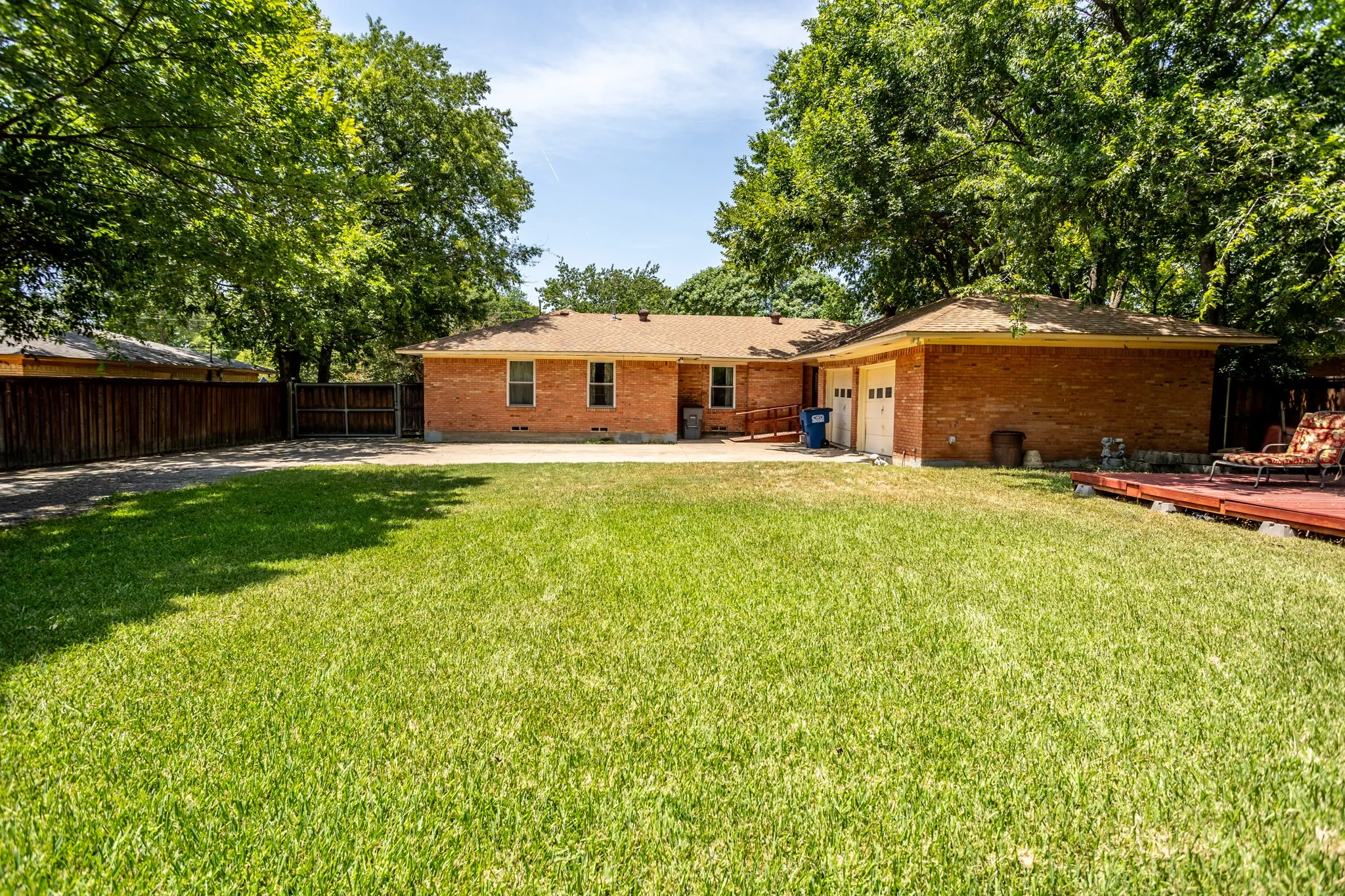 Back has wood fence, large grass area, extra parking, privacy gate.  Entrance to den has a handicap ramp.
