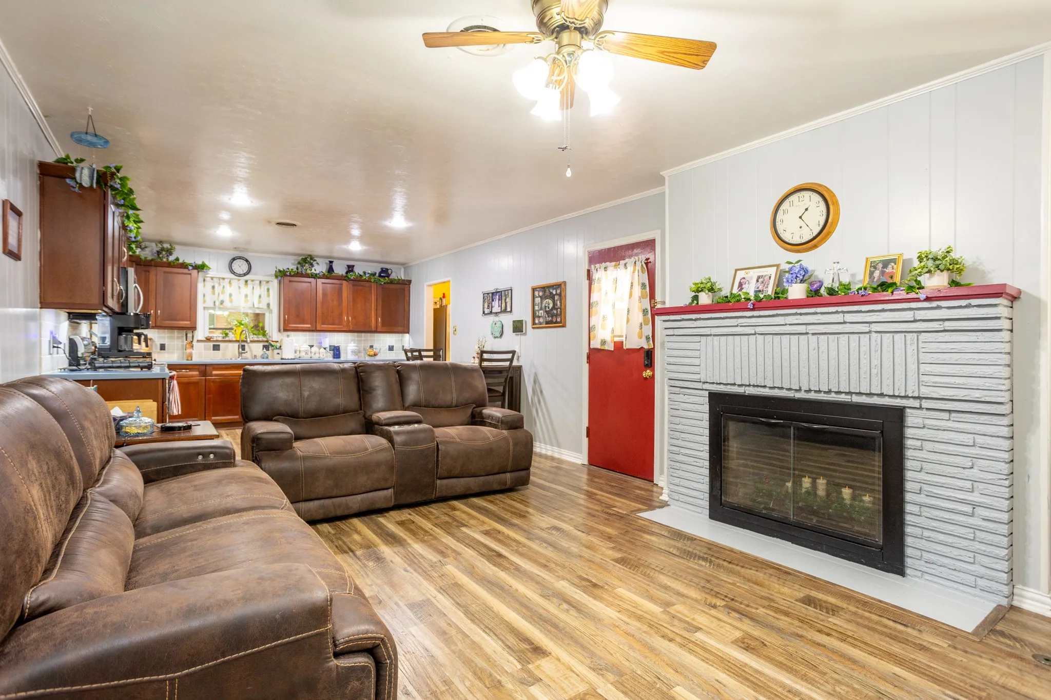 Originally this was called a living kitchen and it let all the family be in one space sharing with each other and the kitchen being part of the events in living space.  Fireplace is a mock now but still great for hanging the stockings.  Door to back yard.
