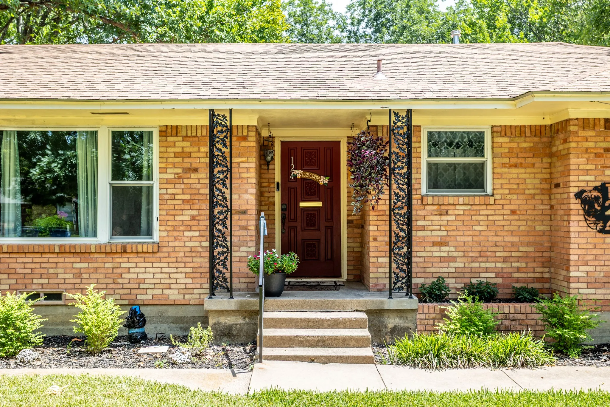 Welcoming entry with planter box.  New owner could add more plantings to enhance it even more. landscaping and ability to have front porch flowers. Solid wood front door.