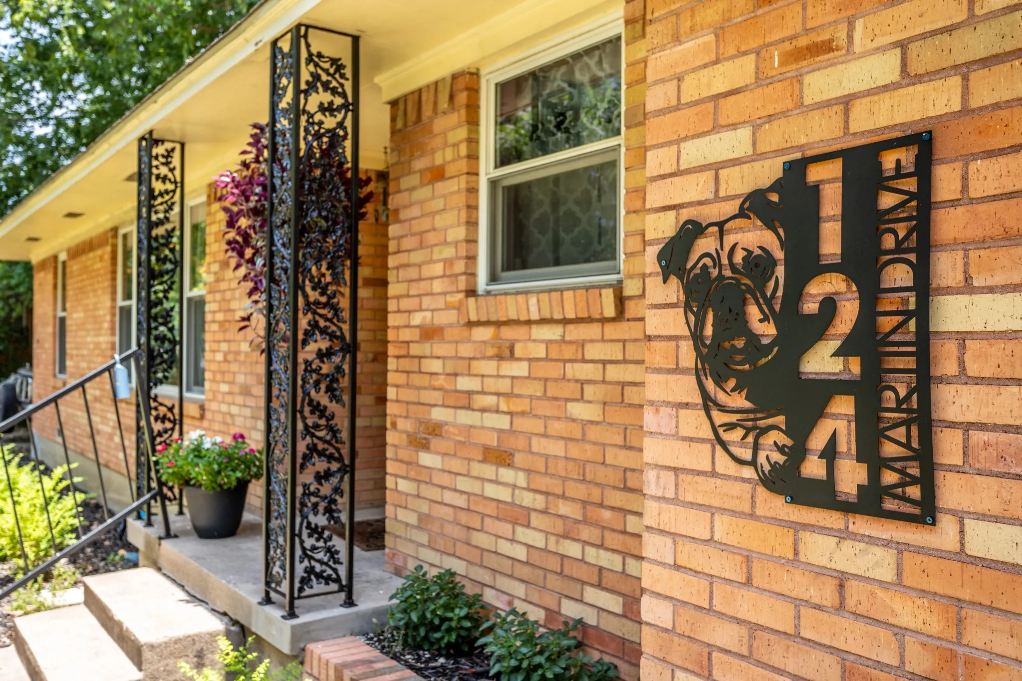 Side view of entry highlights wrought iron features.