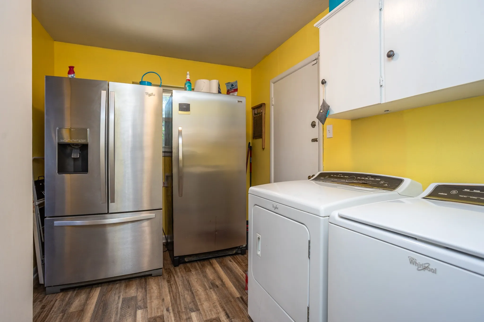 Next to kitchen is refrigerator and freezer space.  Door leads to garage.