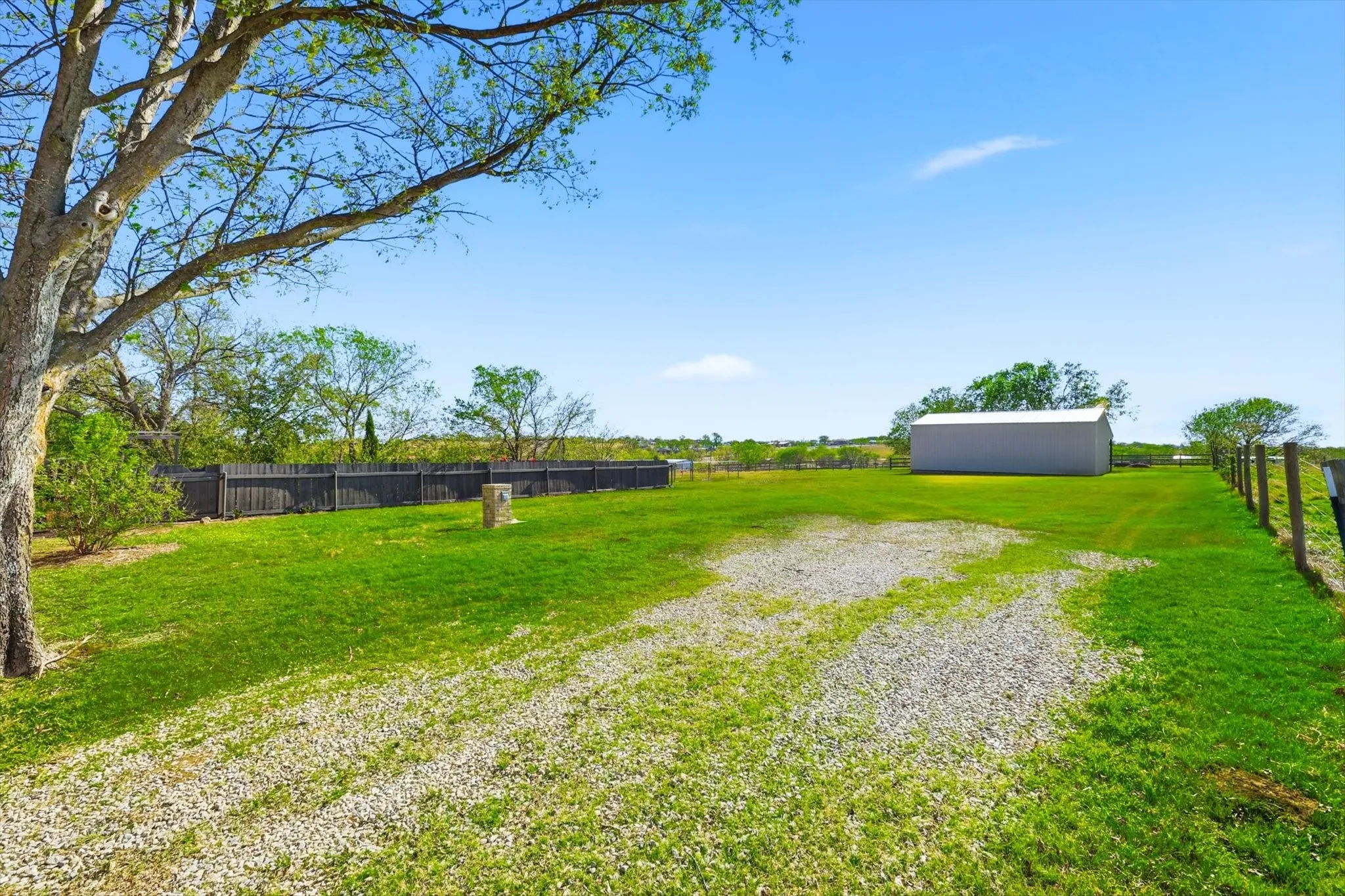 View of yard featuring a pole building and an outdoor structure
