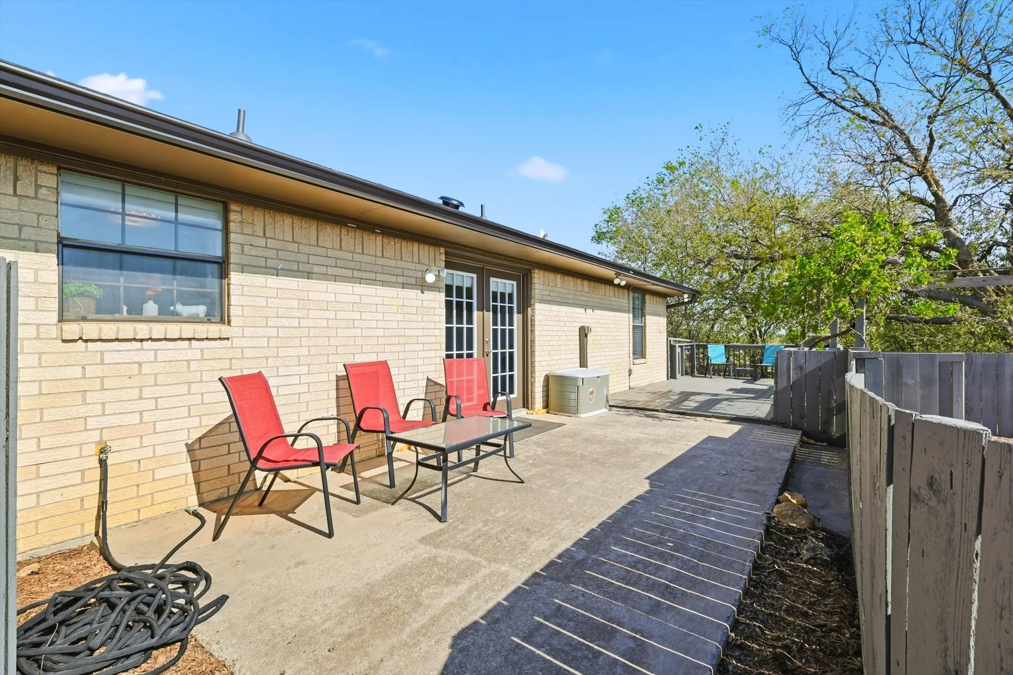 Fenced backyard with a patio
