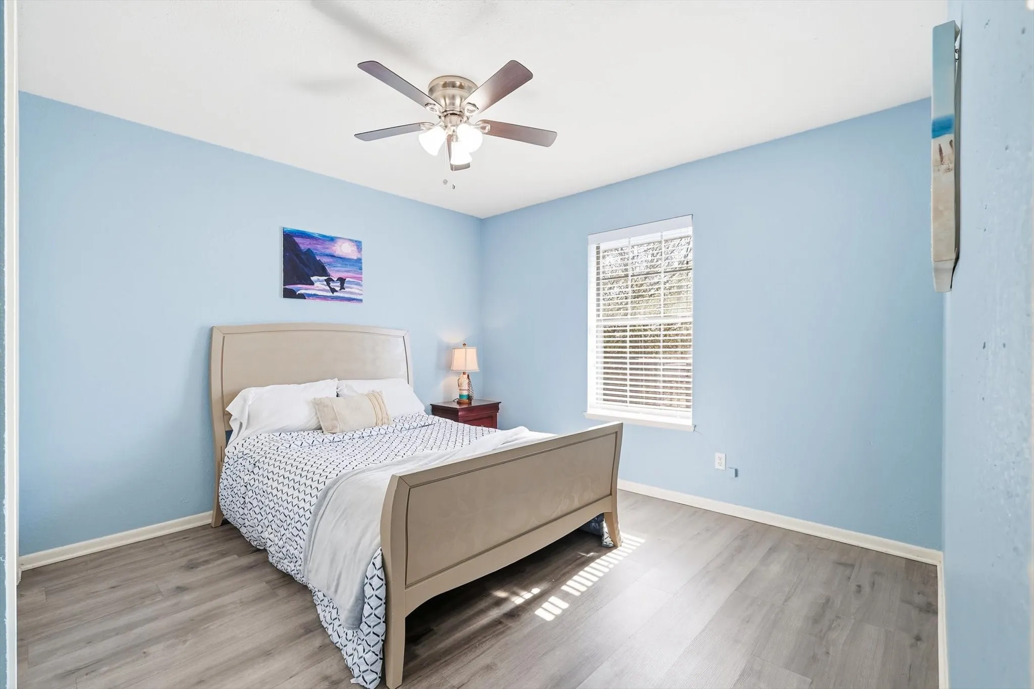 Bedroom with closet, fan, new flooring.