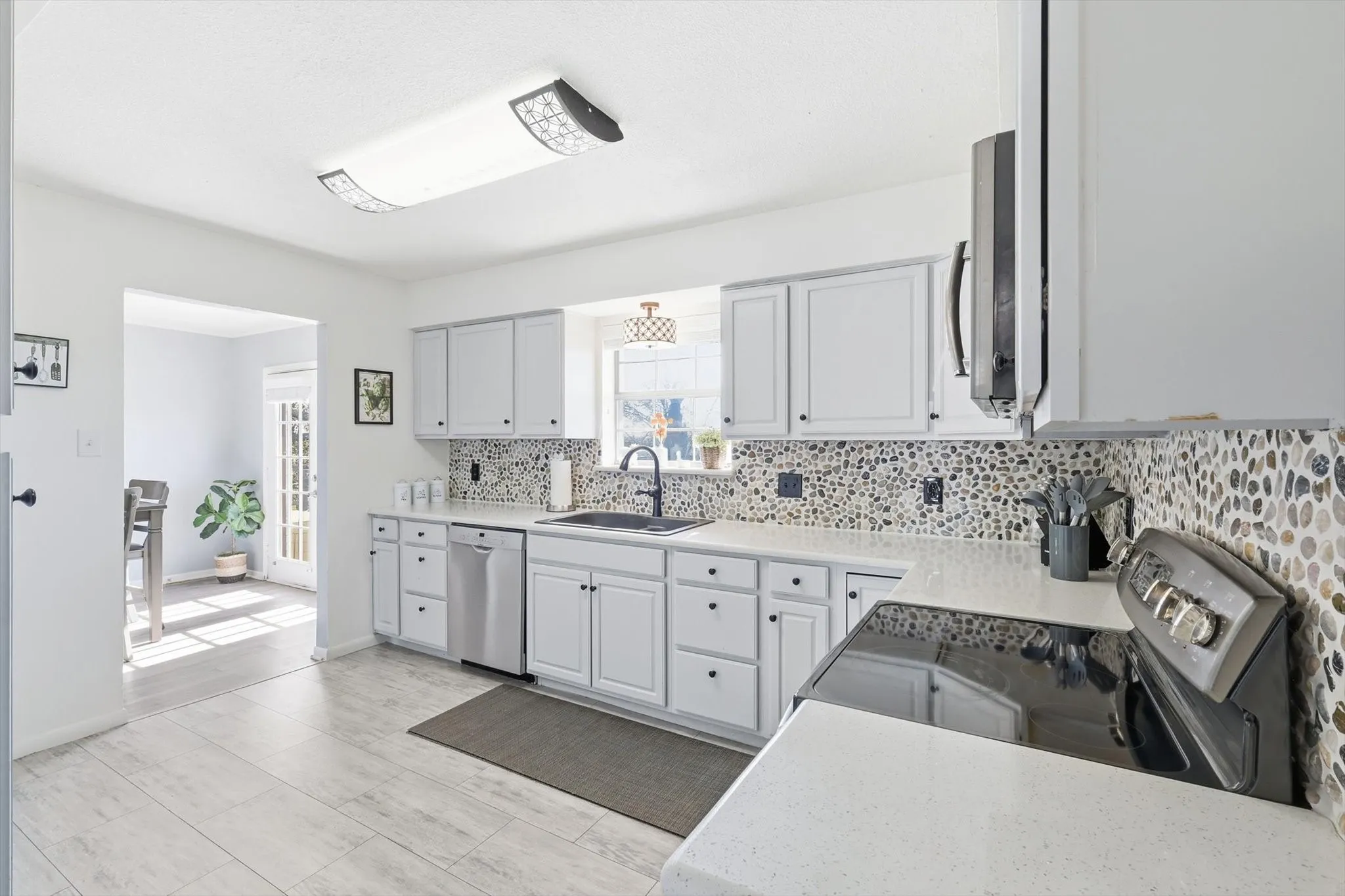 Gorgeous painted cabinets, new countertops, flooring, and backsplash!
