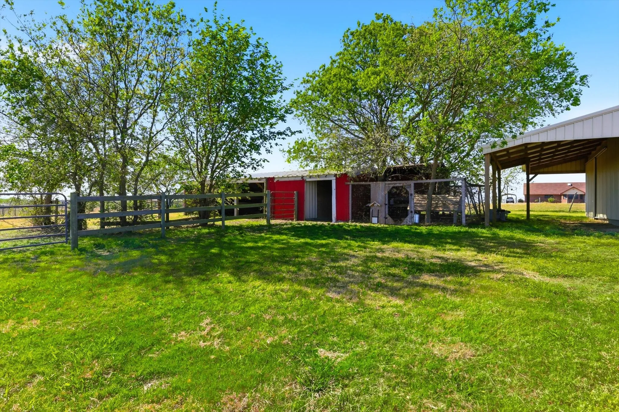View of exterior with barn, stables and building.