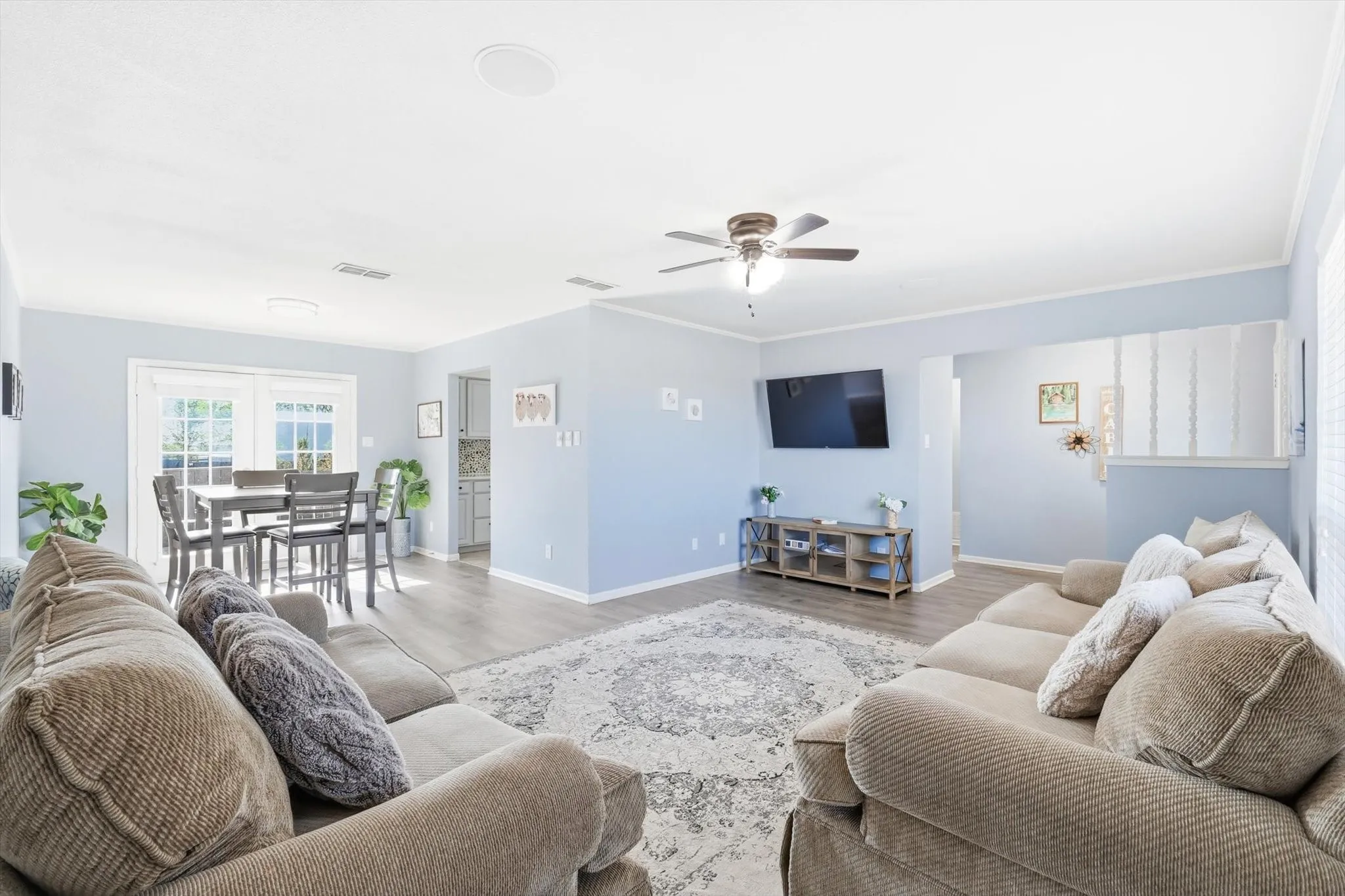 Large furnished living space with ceiling fan, new flooring and plenty of space!
