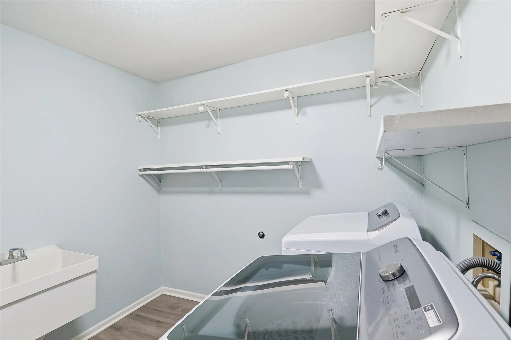 Huge utility room with washer and dryer, sink and storage!
