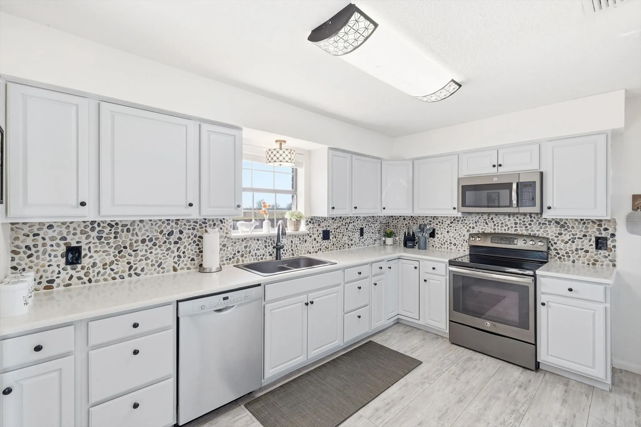 Gorgeous painted cabinets, new countertops, flooring, and backsplash!