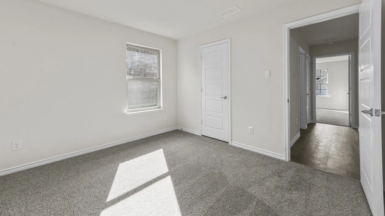 Carpeted room featuring a single window and light gray walls