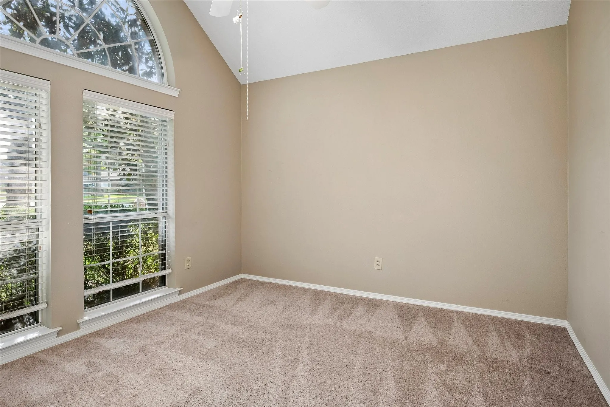 Second bedroom with front-facing windows.