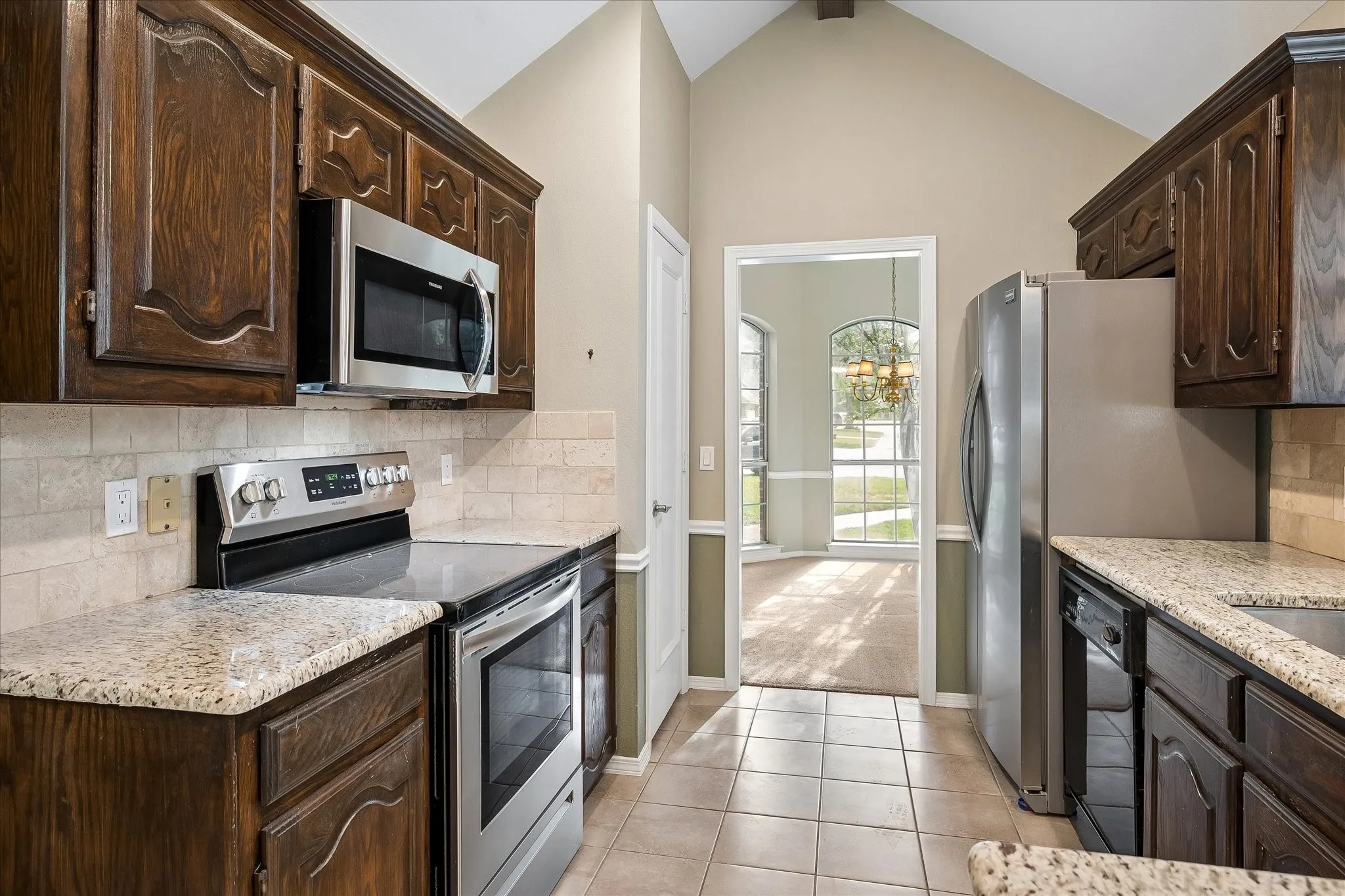 Kitchen with view to dining room and front of home.