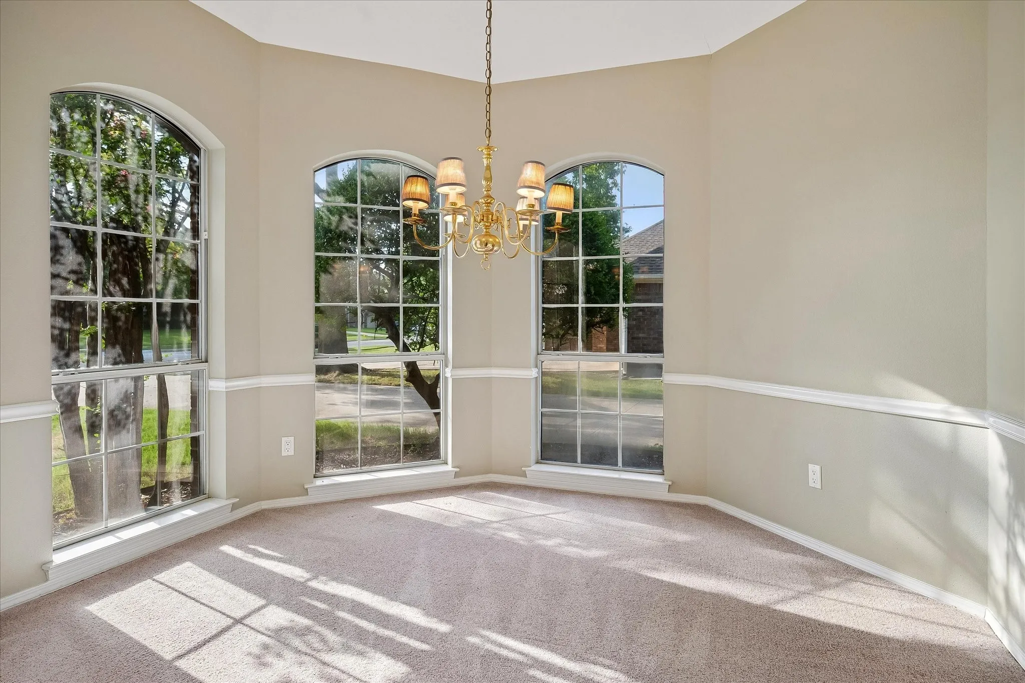 Dining room faces west at the front of home receiving lovely dappled afternoon light.