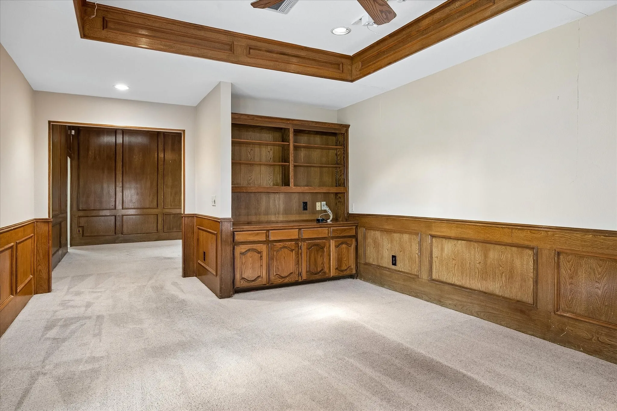 Secondary living room with great built-ins and wood panelling. Opens into the primary living room.