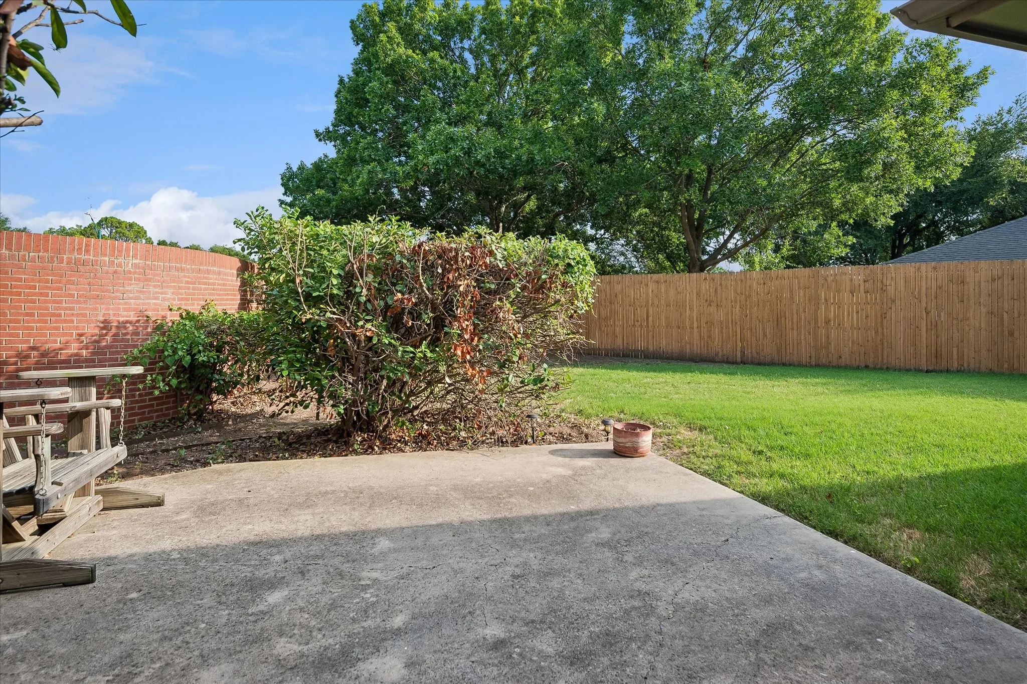 Southside of backyard with view of the sound barrier wall and the southern fence.