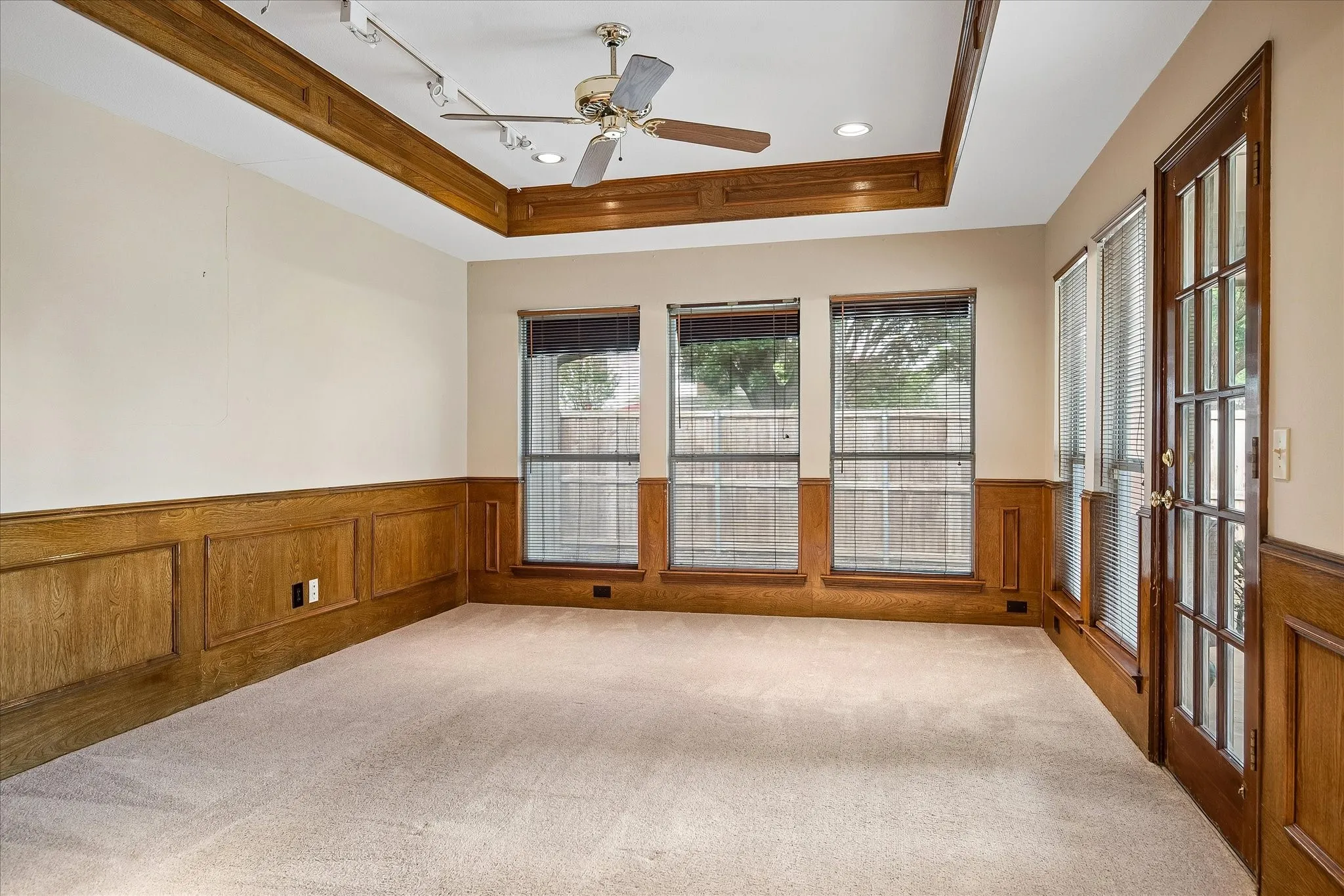 Secondary living room with view to backyard and door to rear patio. Primary living room is behind the photographer.