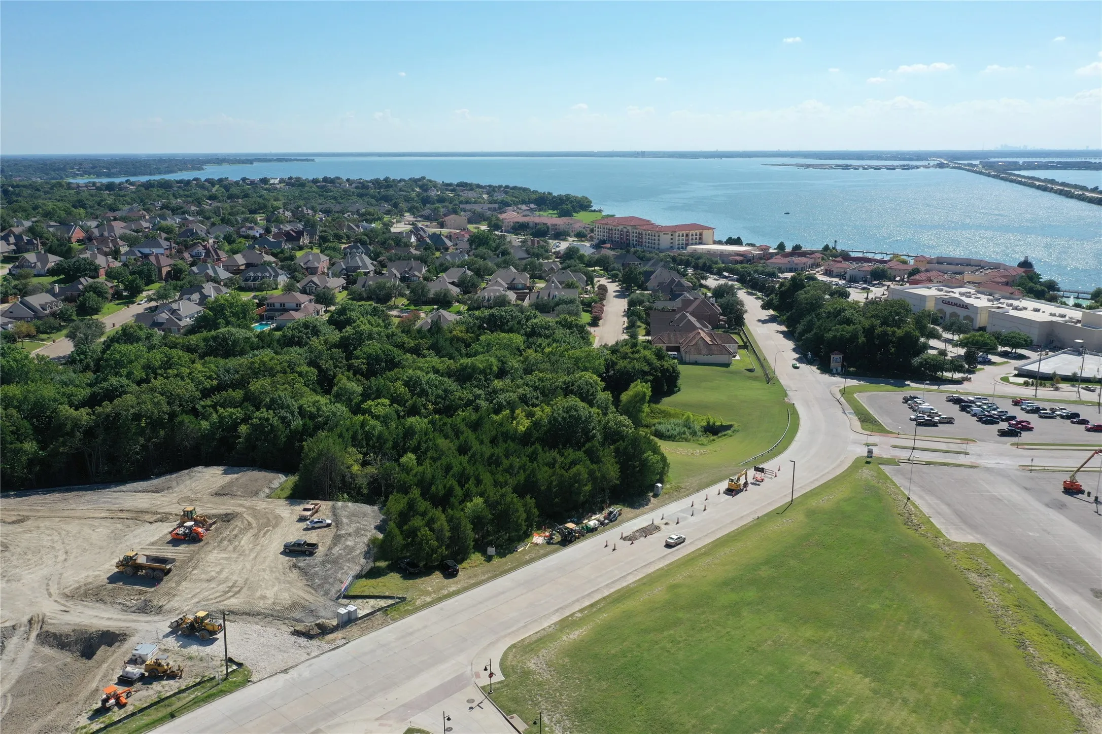 Aerial perspective showcasing expansive grounds with mature tree coverage, manicured lawn areas, and curved driveway access
