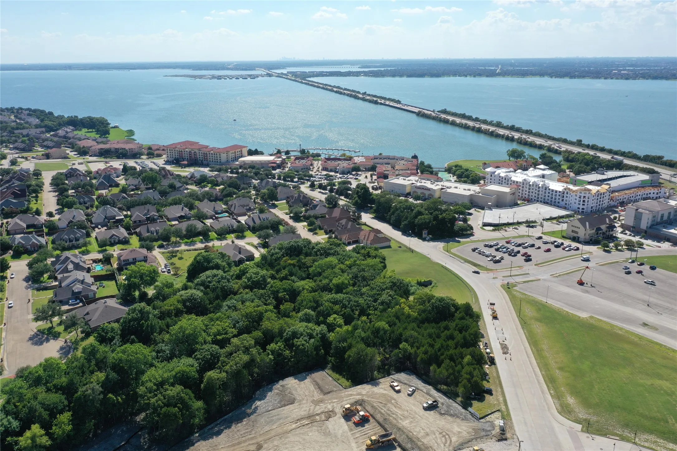 Aerial view showcasing this waterfront community property with mature landscaping, established residential neighborhood, and direct proximity to the bay
