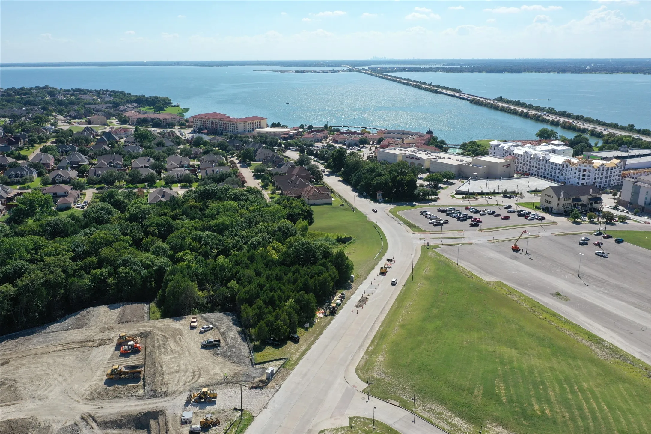 Expansive land parcel featuring cleared areas ready for development, bordered by established residential properties and mature trees