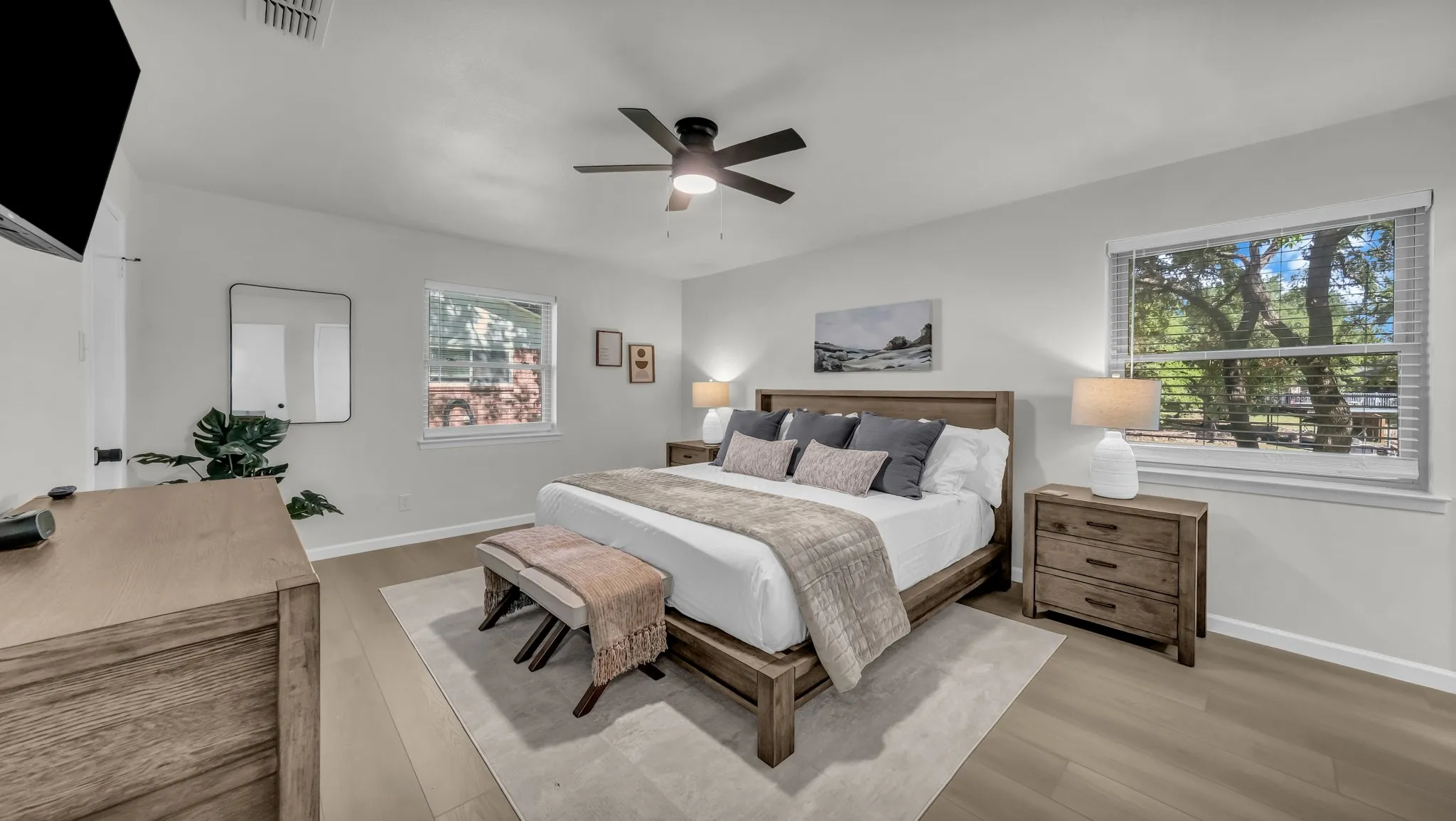 King size bed with window overlooking the lake and backyard activities. Two night stands with drawers and lamps
