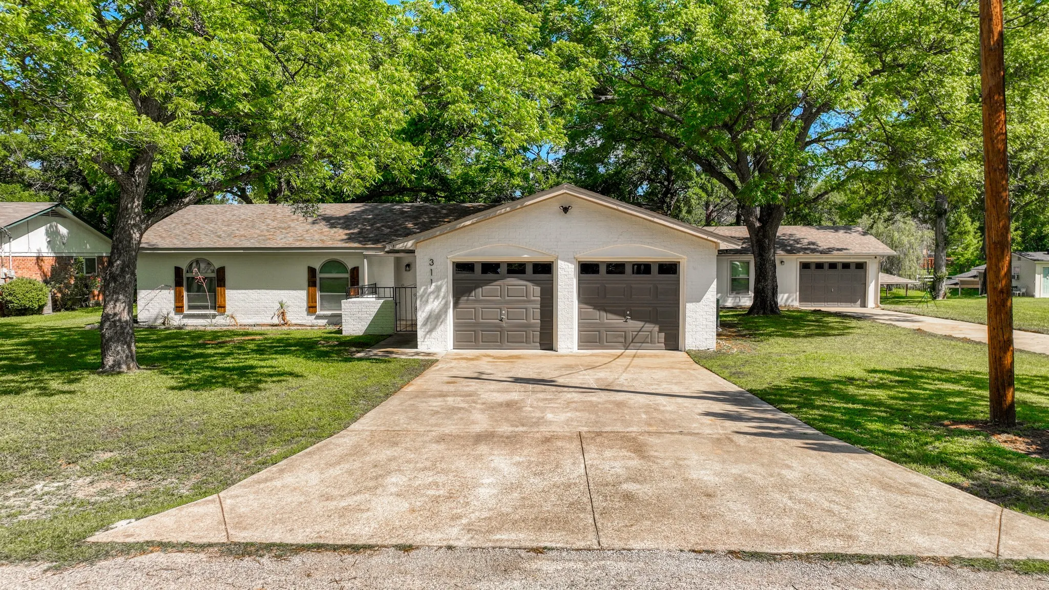 Front of house with double car garage and detached garage. Plenty of room to bring your boat!