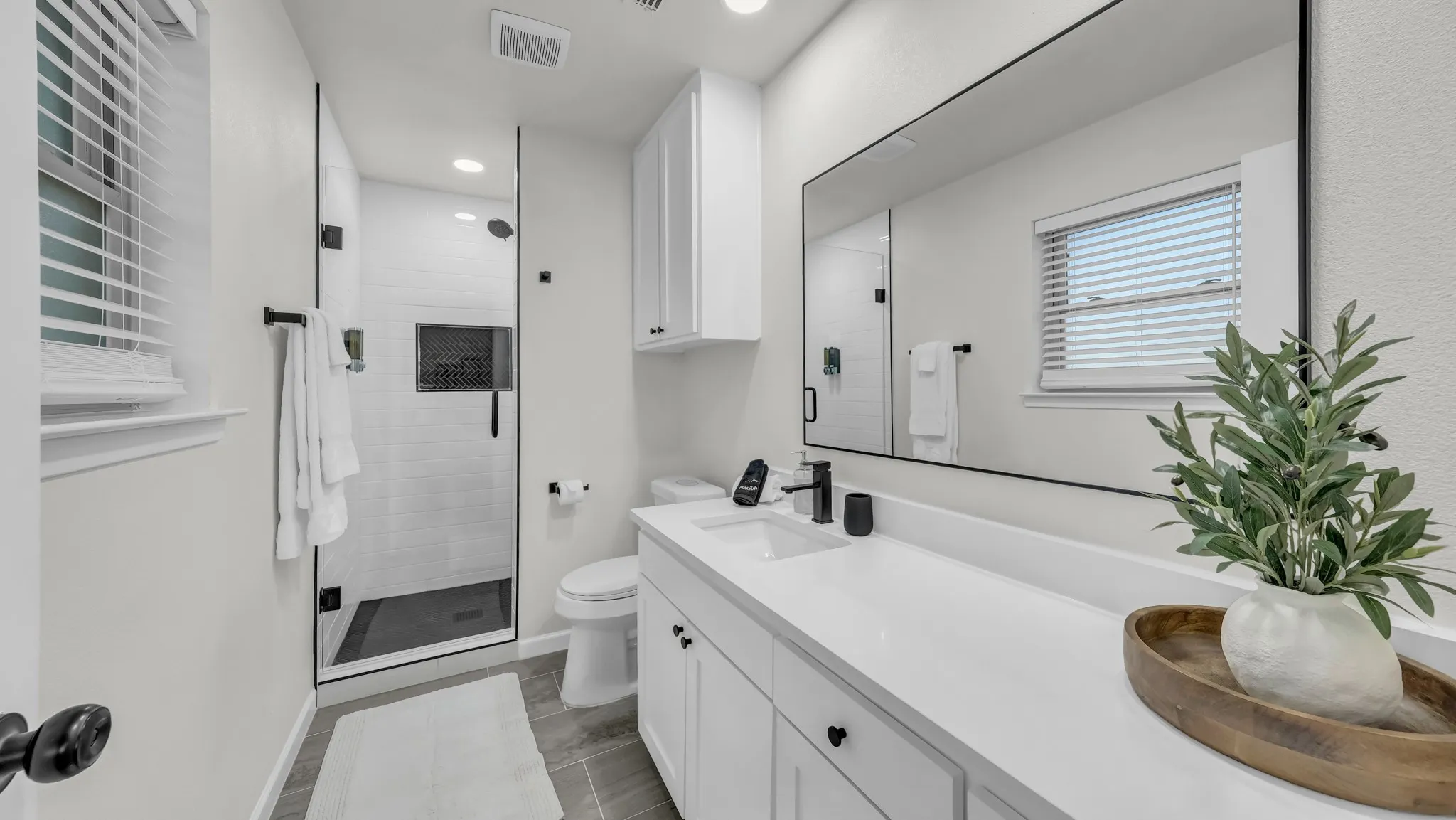 Large mirror, lots of cabinet space and countertop space