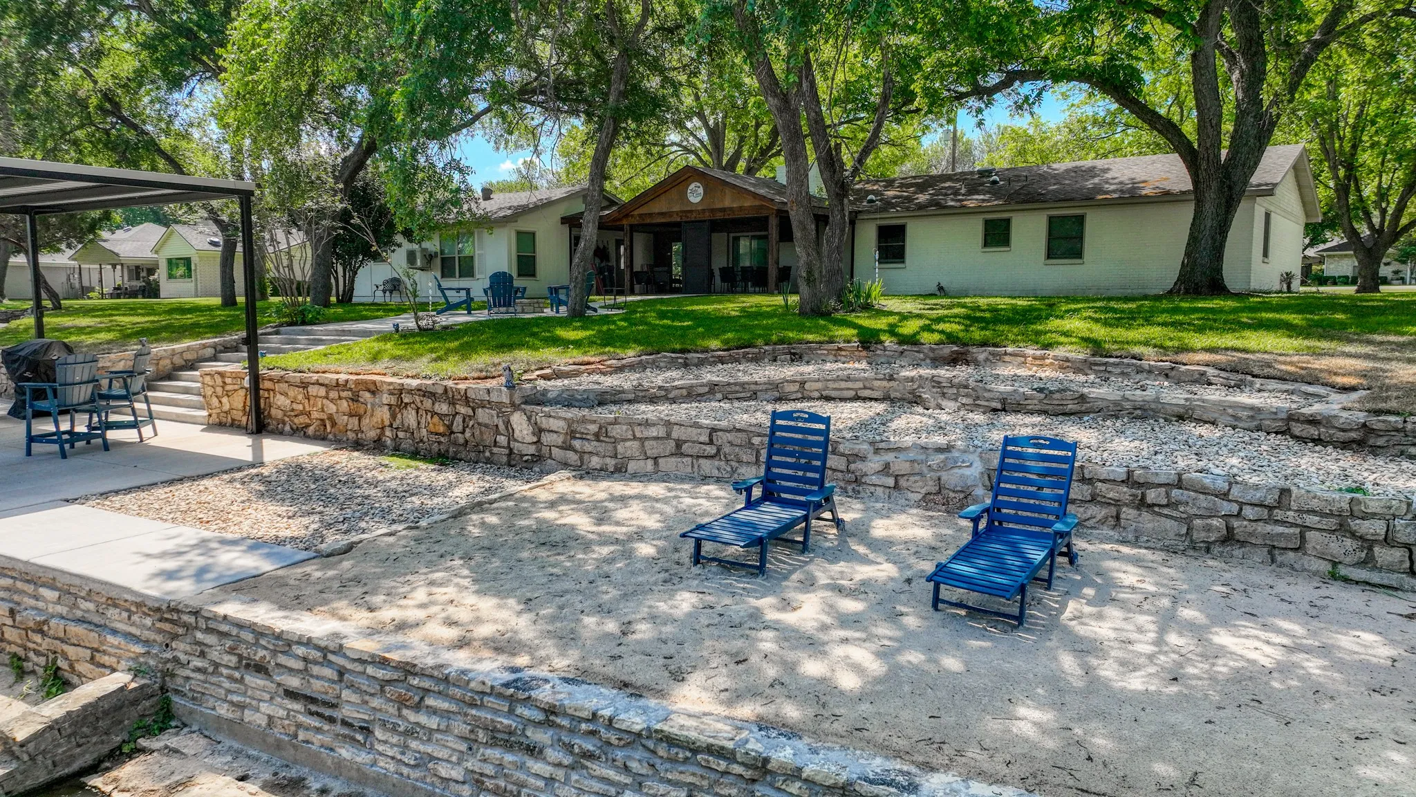 Sandy beach area with lounge chairs. Perfect for sand castle building!