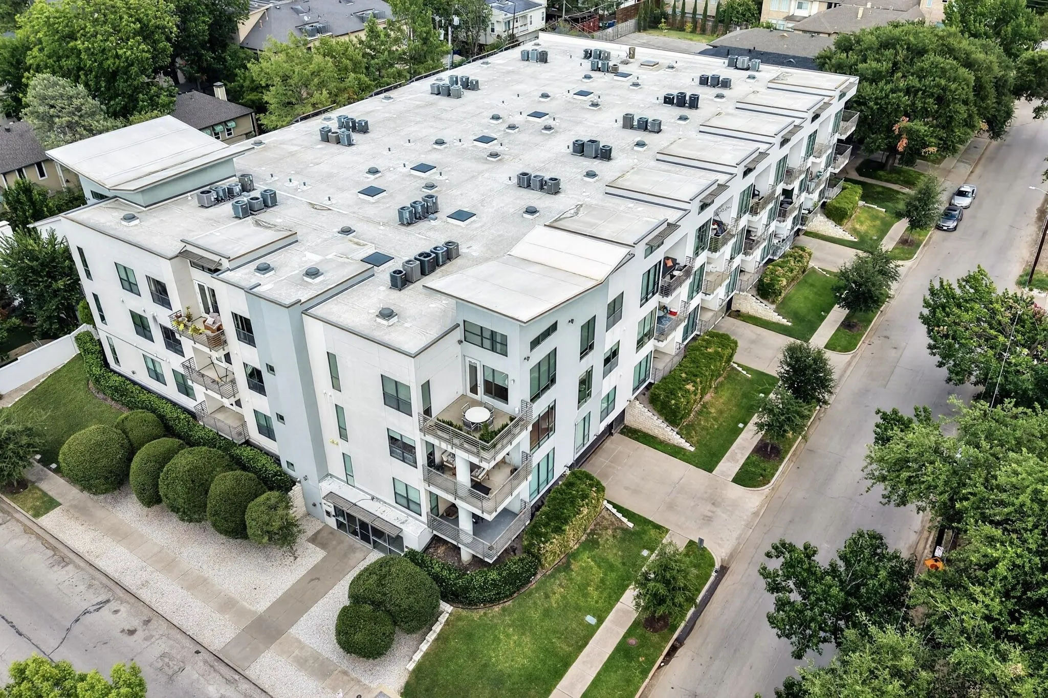 Modern multi-story building featuring clean lines, a flat roof, and individual balconies