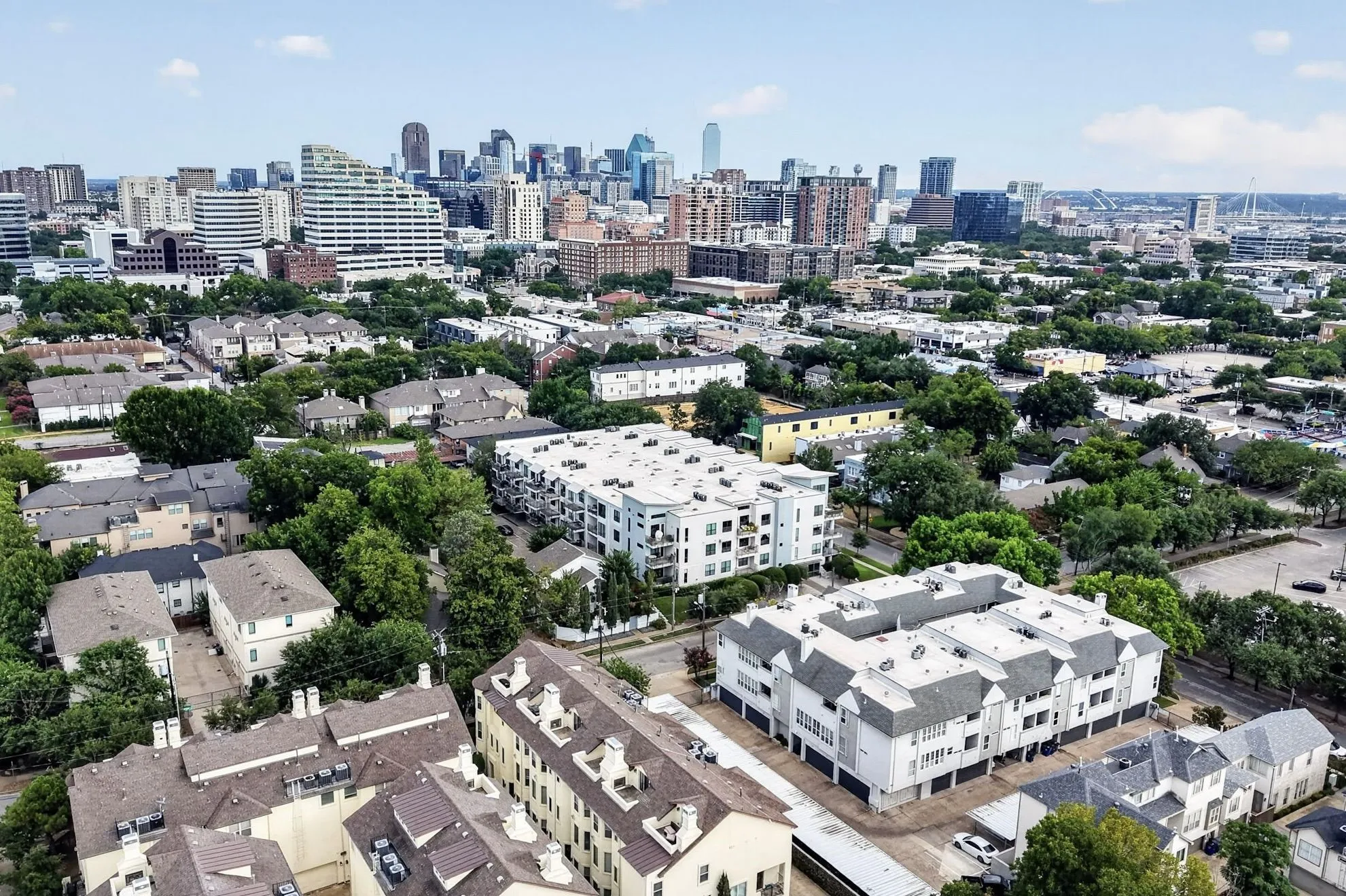 Urban cityscape with multiple residential buildings and a distinct city skyline