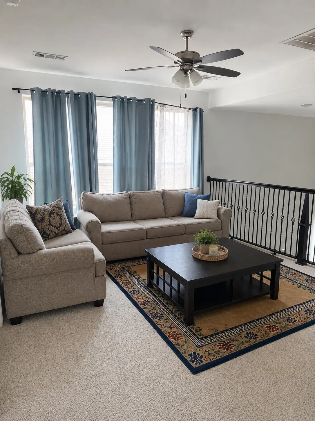 Recessed lighting, ceiling fan with integrated lighting, multiple windows, and black metal railing