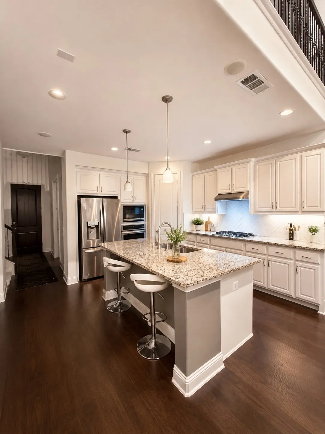 Kitchen with wood-finish flooring, recessed lighting, and a two-tier island with stone-finish countertops
