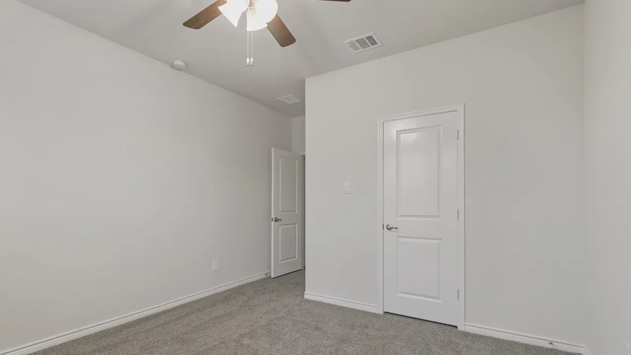Neutral wall tones with grey carpet flooring