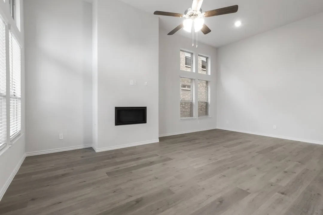 Spacious interior with high ceilings and wood-finish flooring