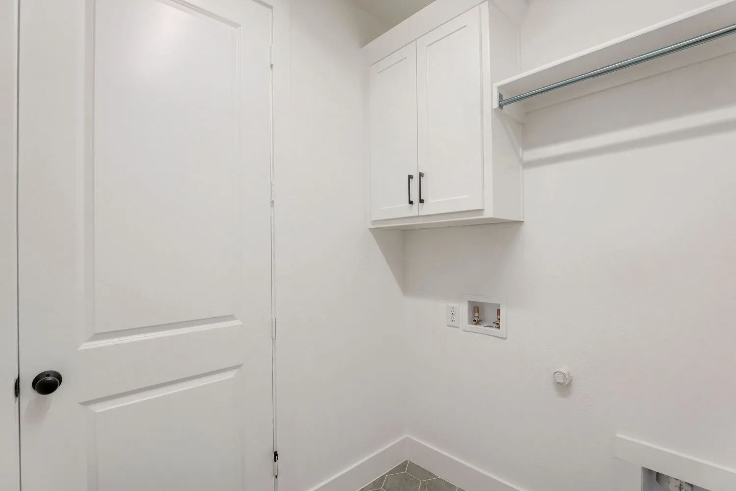 White shaker-style cabinetry with matte black hardware