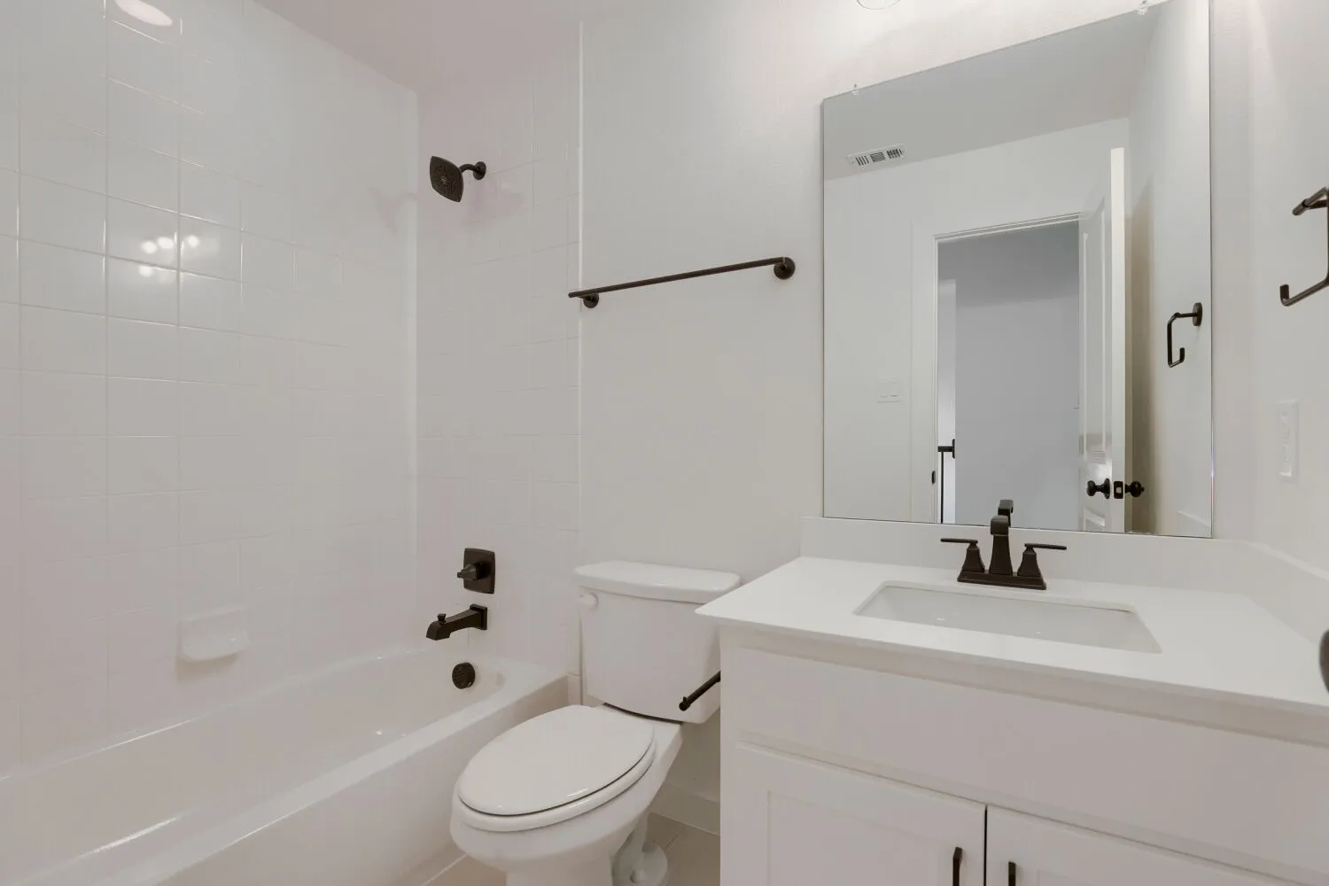 White vanity with a rectangular sink and white countertop