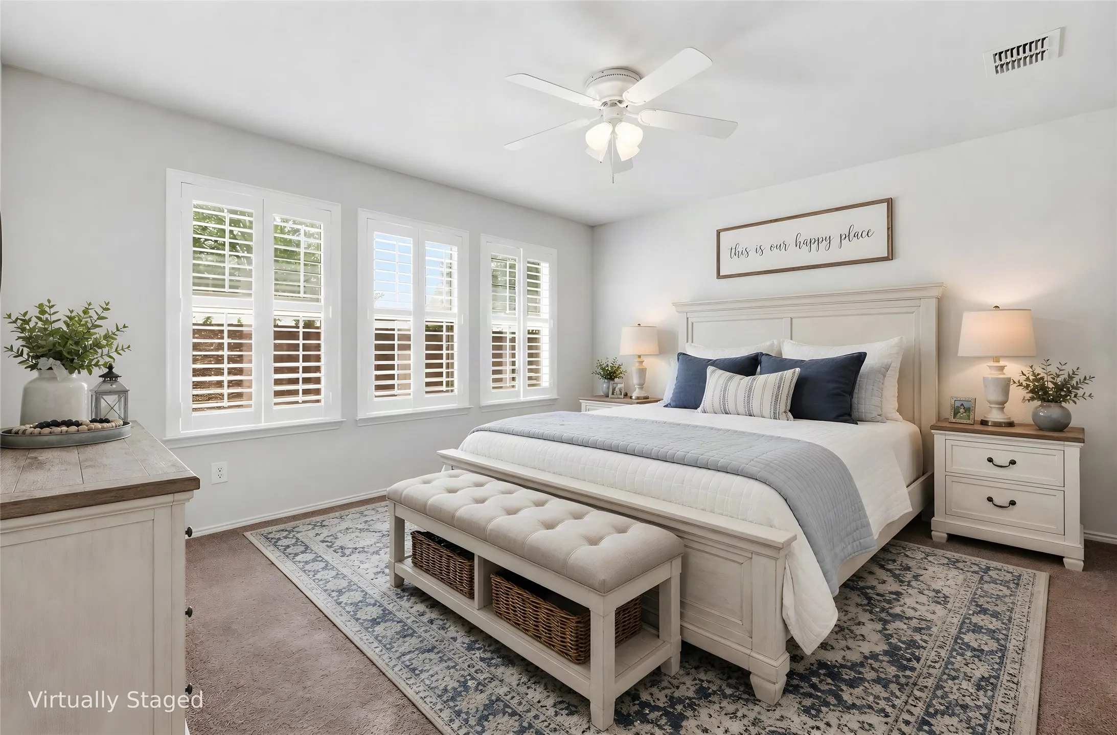 Primary Bedroom featuring three windows with white plantation shutters, a ceiling fan with integrated lighting, and carpet flooring