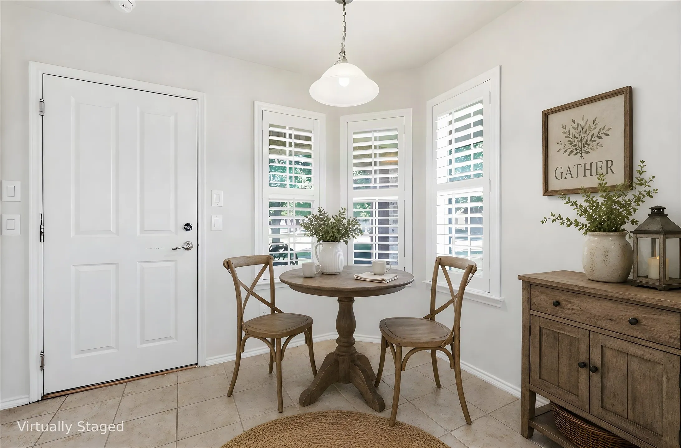 Bright interior space featuring a paneled door, three windows with white plantation shutters, and a cream tile floor