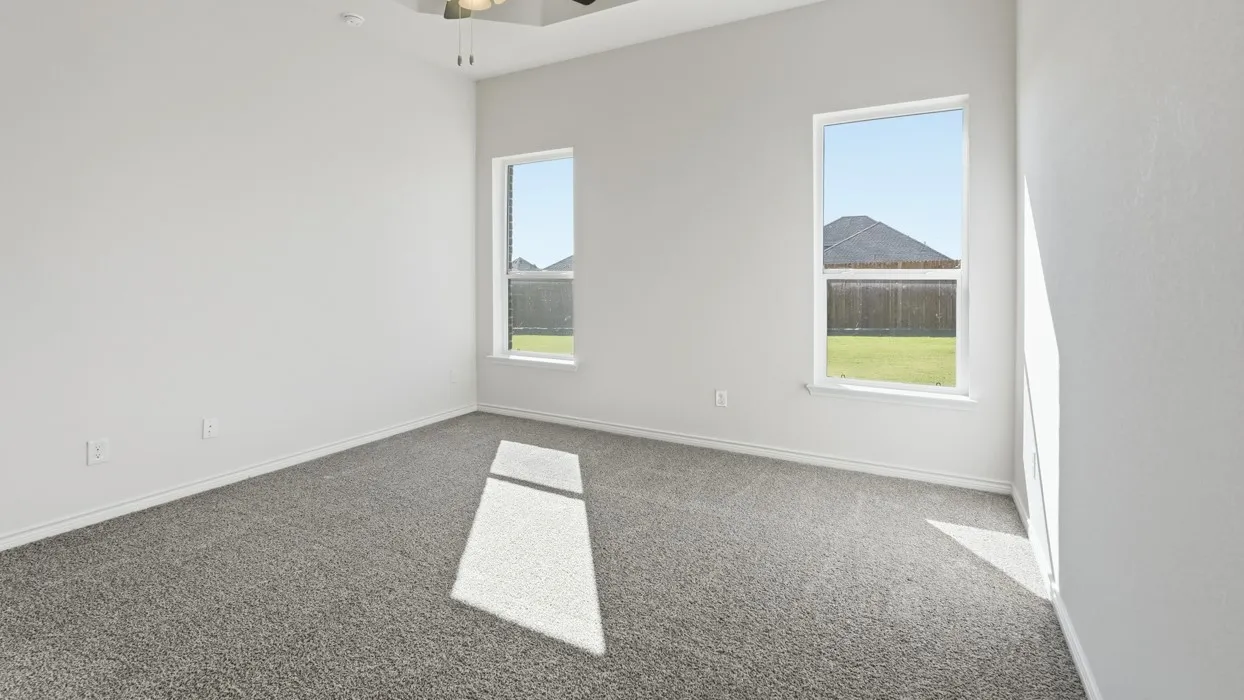 Bright and airy bedroom featuring neutral wall finishes, carpet flooring, and dual windows framing scenic mountain and landscape vistas