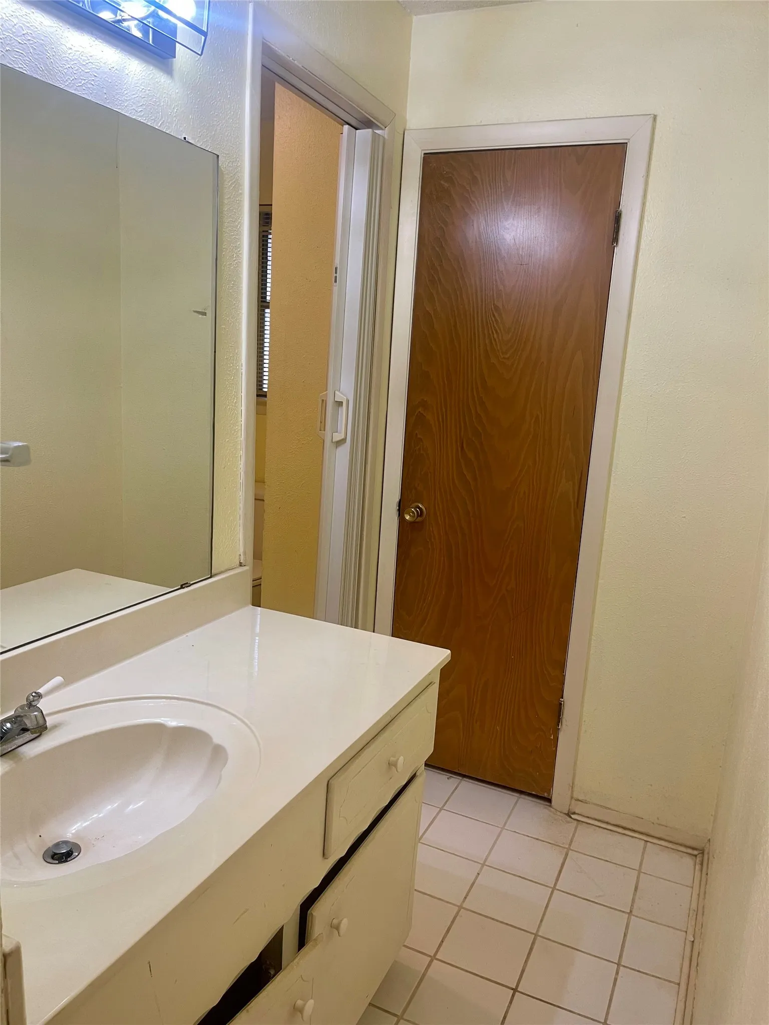 Bathroom vanity with an integrated white sink and chrome faucet