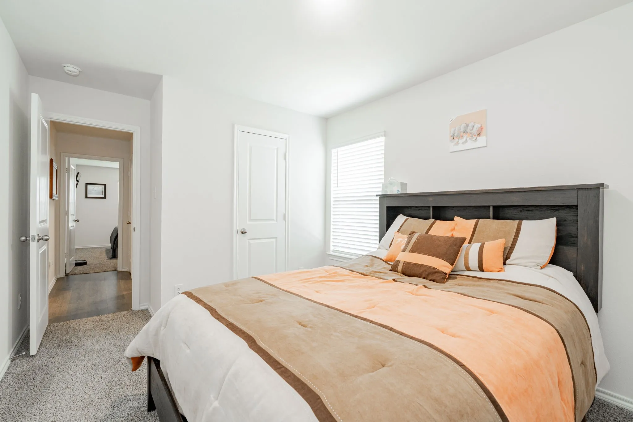 Bedroom featuring baseboards and carpet