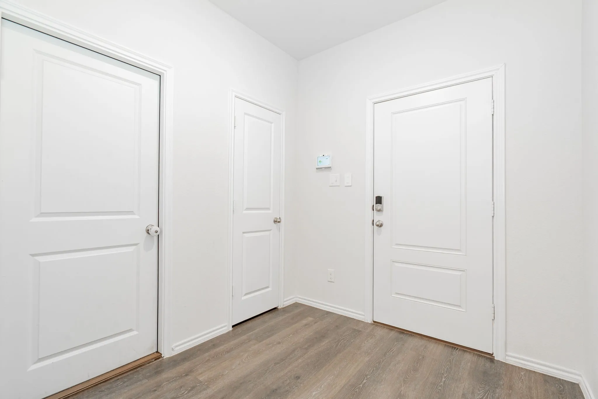 Foyer entrance with baseboards and wood finished floors