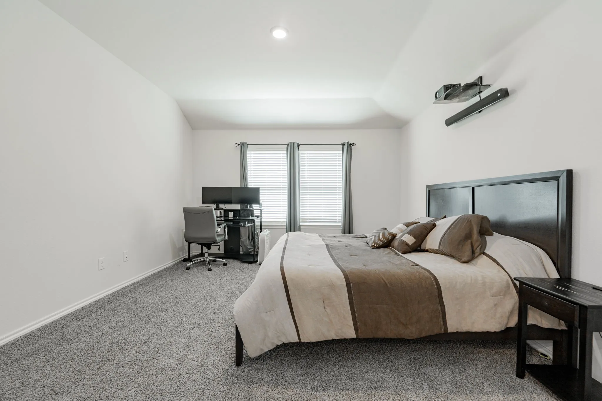 Bedroom with baseboards, vaulted ceiling, and carpet floors