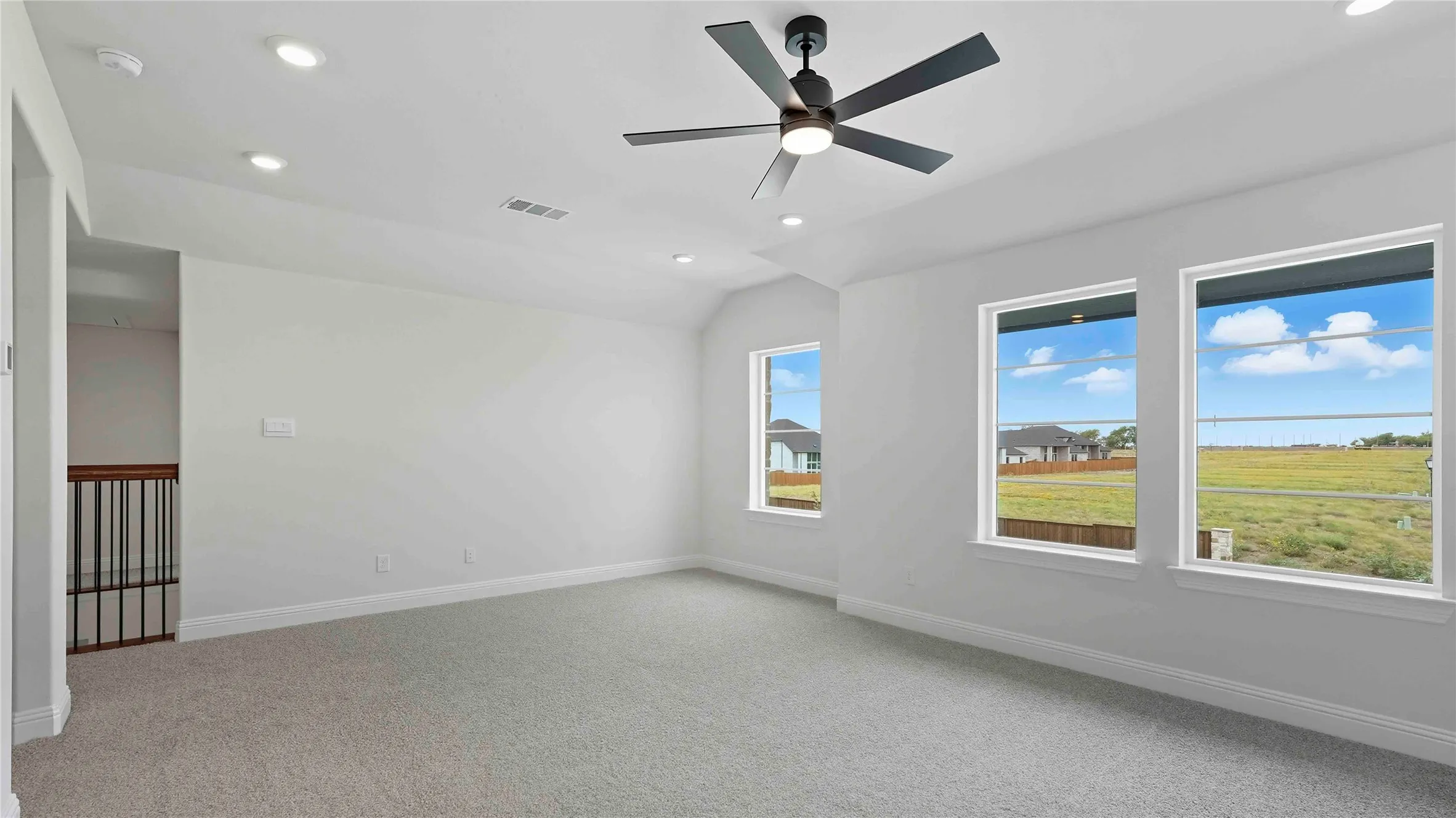 Spacious secondary room featuring neutral carpet flooring, recessed ceiling lighting, and a modern ceiling fan