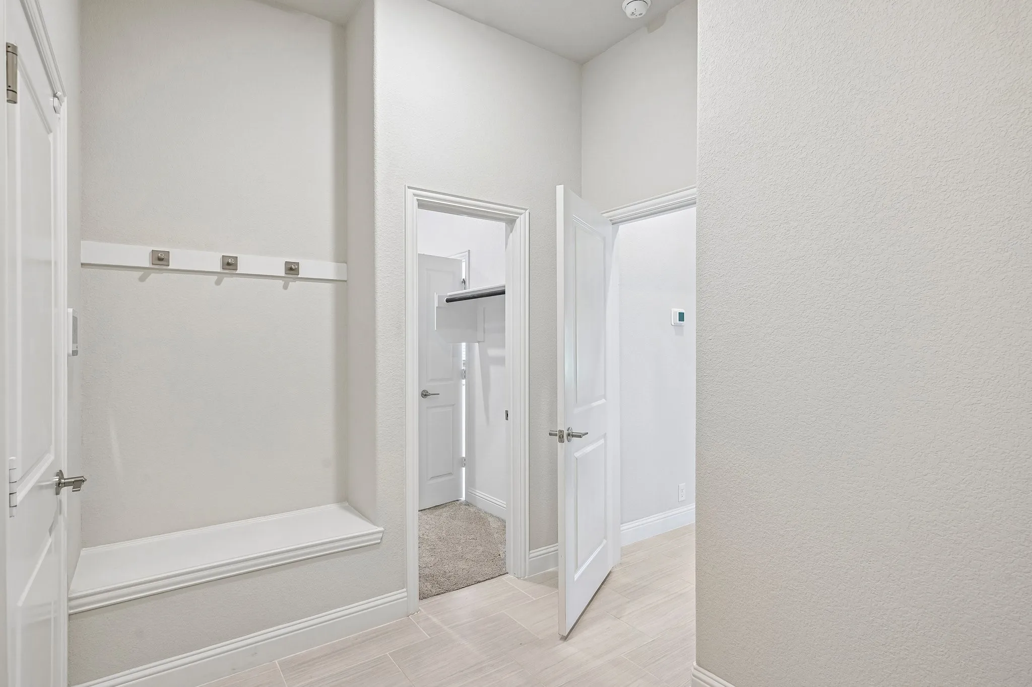 Primary suite mud room and utility room connected to primary suite closet