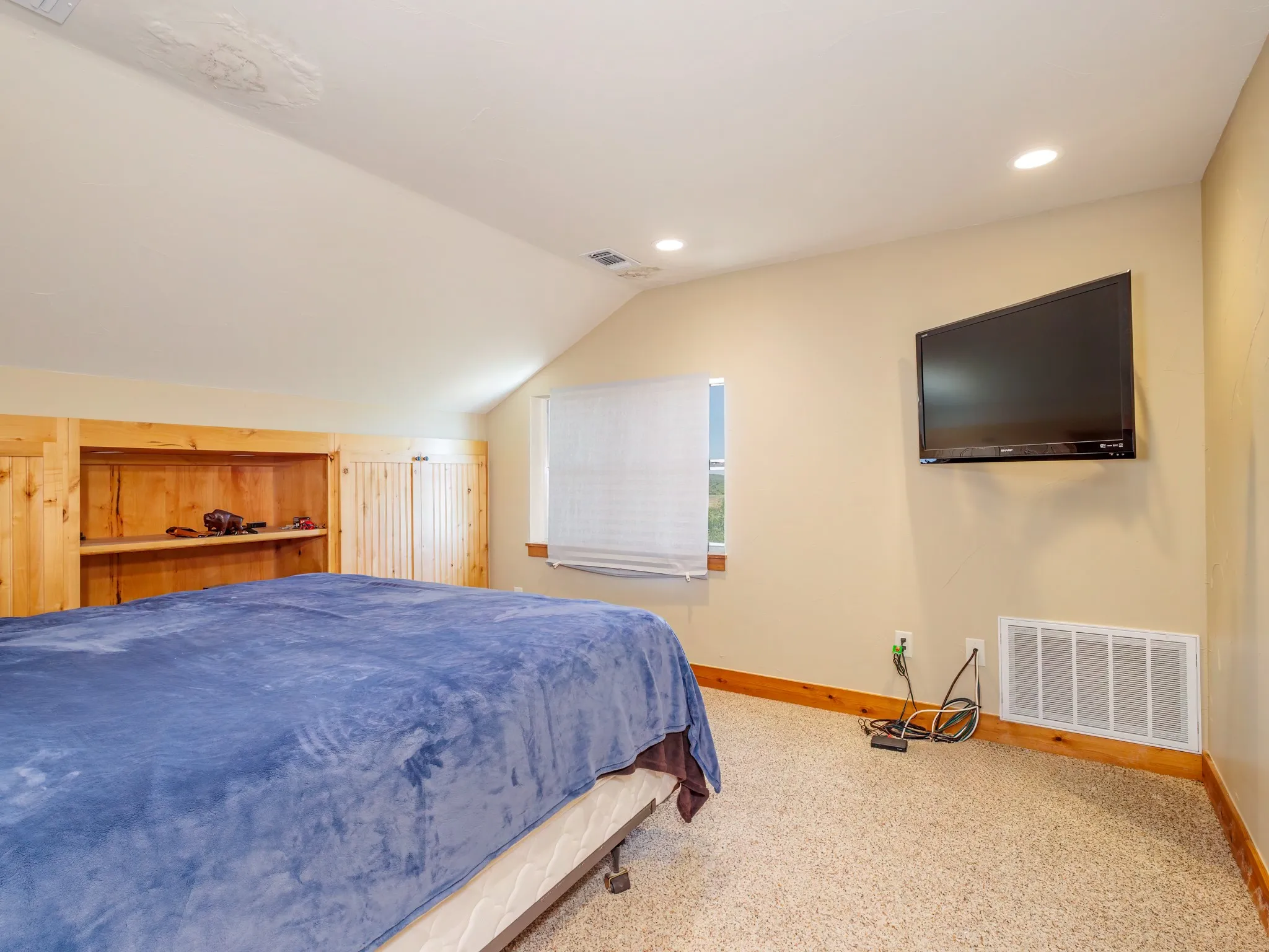 Primary bedroom offers two large storage areas and shelves
