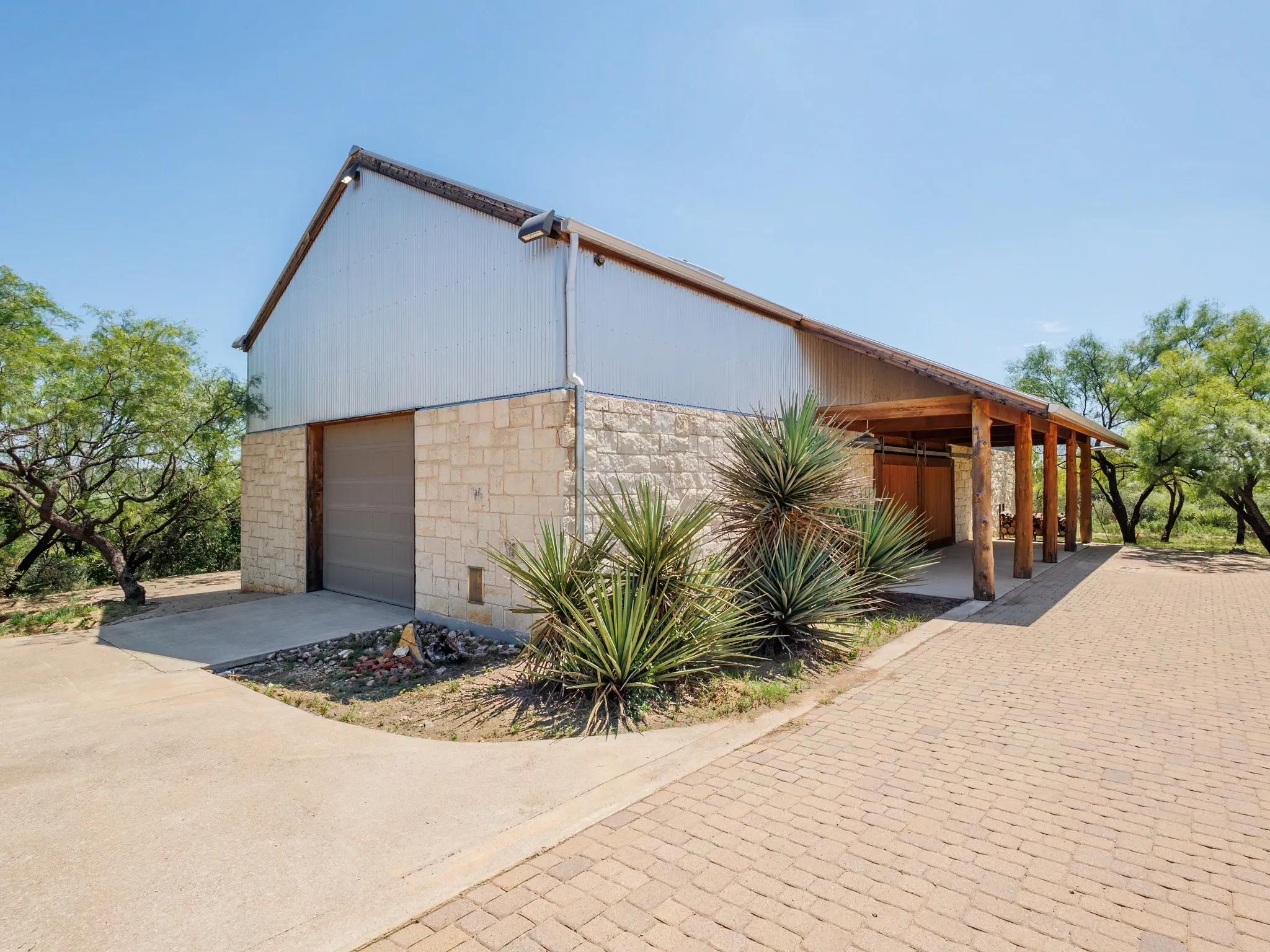 Two car garage over sized with work benches, storage and water treatment